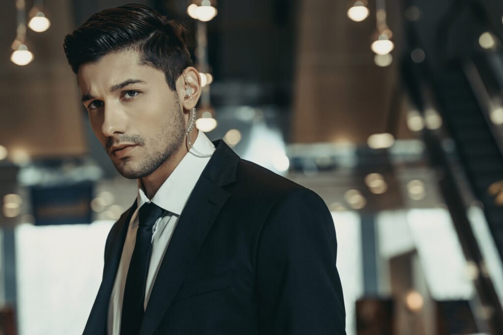 handsome security guard with security earpiece looking away