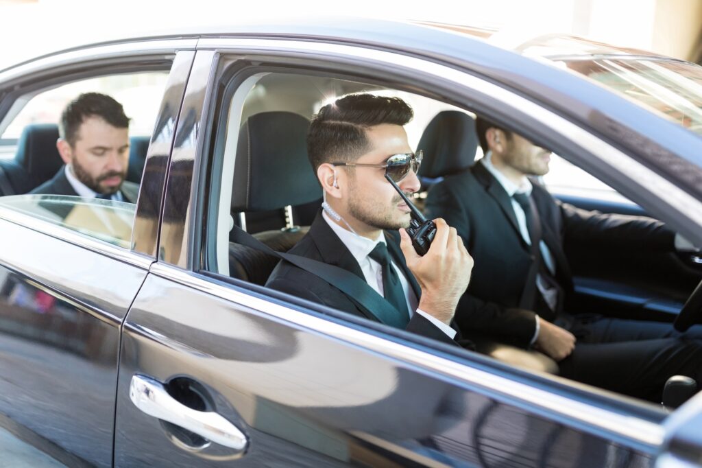 Security Team Transporting VIP In Luxury Car